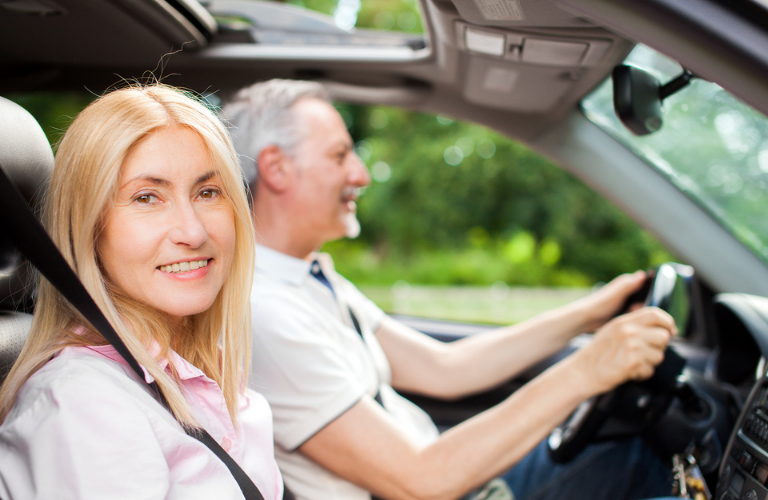 A couple driving a vehicle