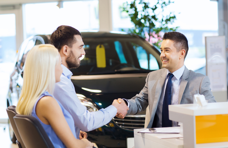 Happy customers talking to a salesman 