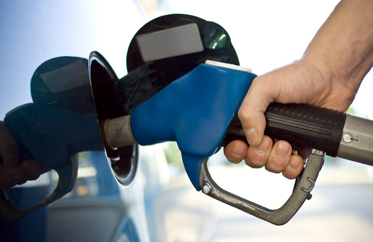 A man filling fuel in a vehicle 