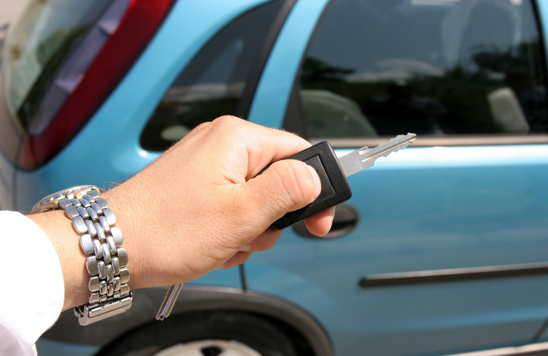 Person using key fob to start a vehicle 