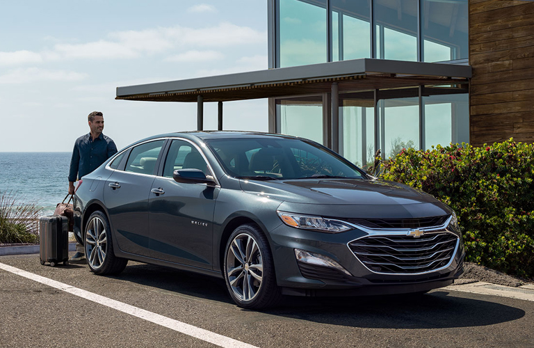 A man walking towards the 2020 Chevrolet Malibu