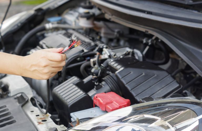 Technician checking a vehicle's engine