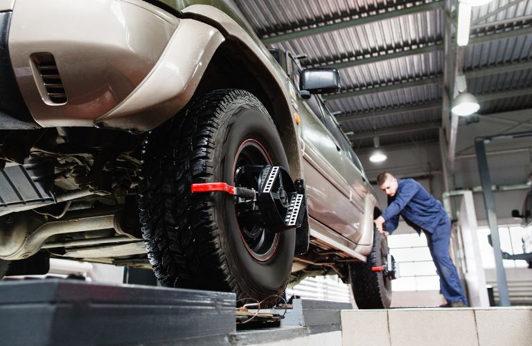 Technician checking wheels of a vehicle