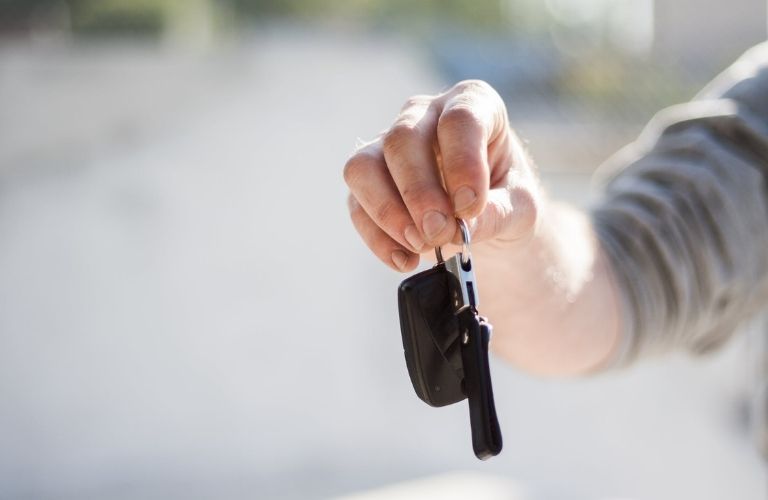 Person handing over a car key