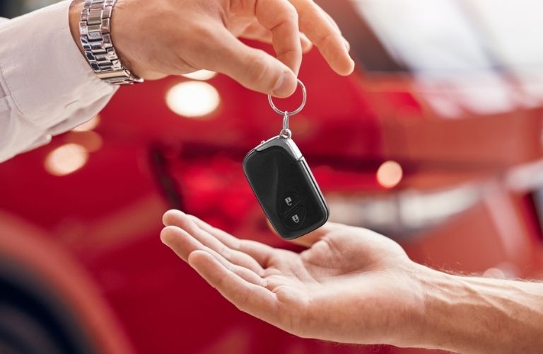 A person handing over car key